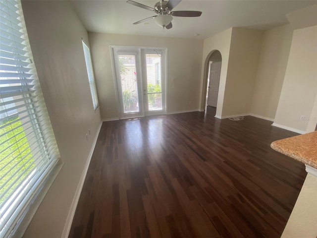 empty room with dark wood-type flooring and ceiling fan