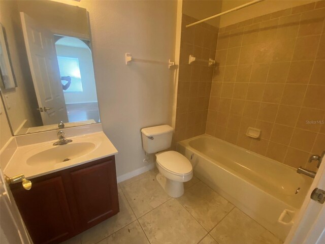 full bathroom with tile patterned flooring, vanity, toilet, and tiled shower / bath