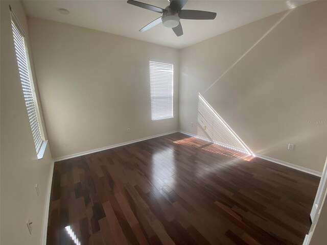 unfurnished room with ceiling fan and dark hardwood / wood-style floors