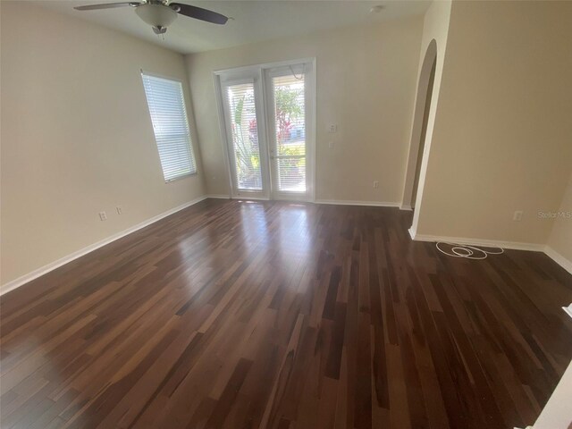 spare room featuring ceiling fan and dark hardwood / wood-style floors