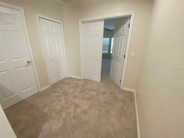 unfurnished bedroom featuring light colored carpet