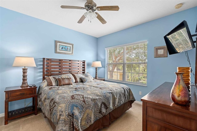 bedroom with light colored carpet and ceiling fan