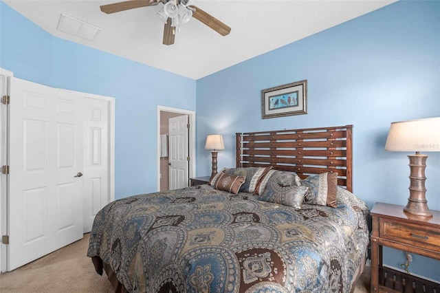 bedroom with light carpet, ceiling fan, and a closet