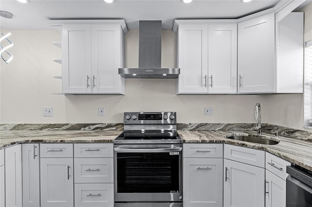 kitchen featuring wall chimney exhaust hood, appliances with stainless steel finishes, sink, and white cabinets