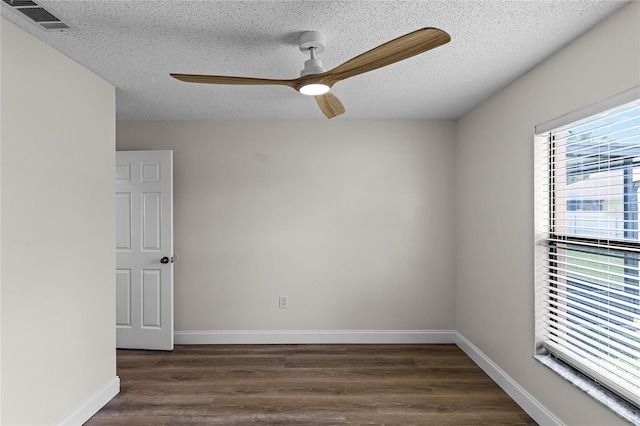 unfurnished room with a textured ceiling, ceiling fan, and dark hardwood / wood-style floors