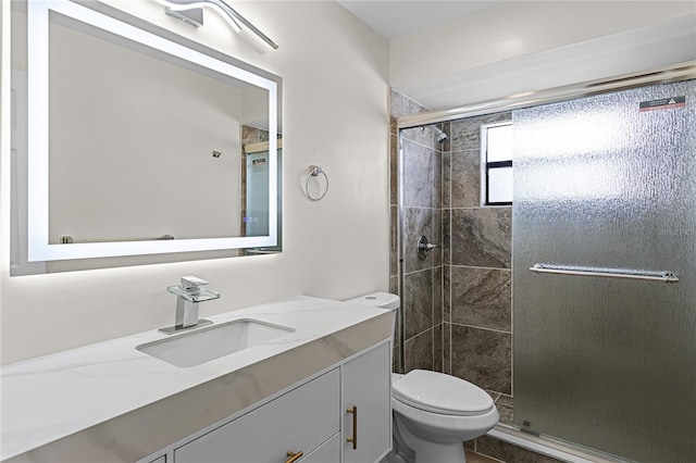 bathroom with walk in shower, toilet, and vanity