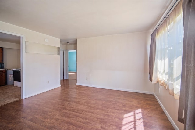 spare room featuring dark hardwood / wood-style flooring