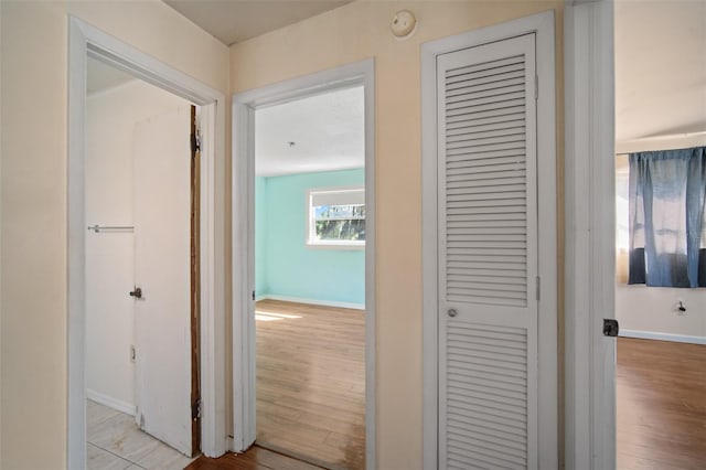 corridor with light hardwood / wood-style flooring