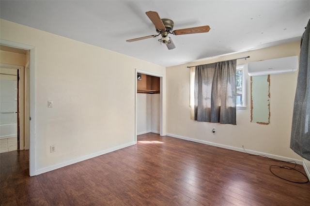 unfurnished bedroom featuring a closet, ceiling fan, dark hardwood / wood-style floors, and an AC wall unit