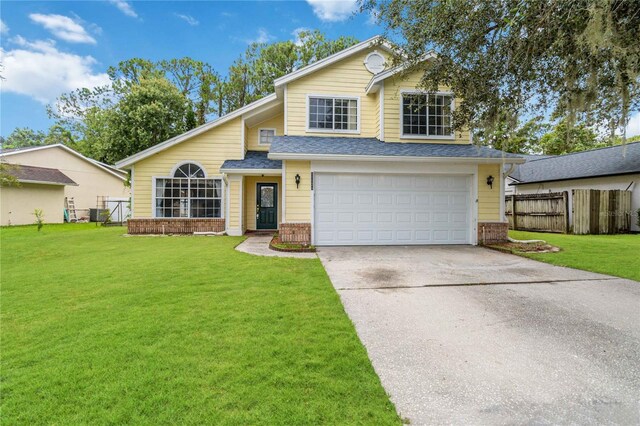 view of front of home with a front yard and a garage