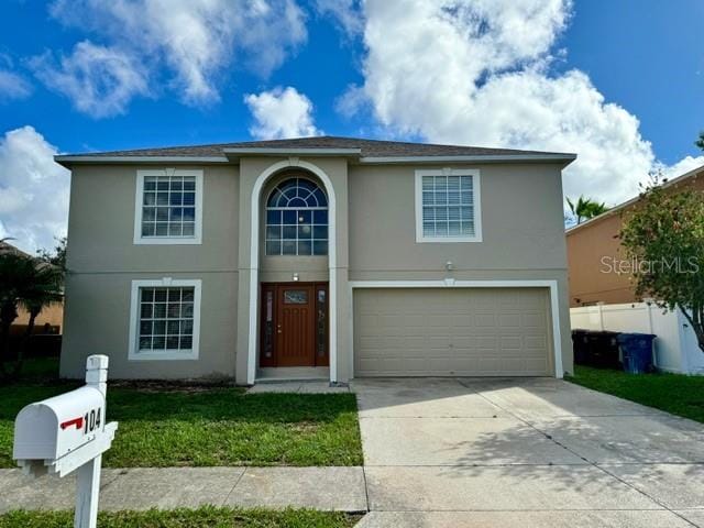 front facade with a garage and a front yard