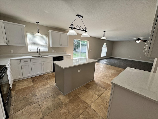 kitchen with a kitchen island, pendant lighting, sink, white cabinetry, and ceiling fan