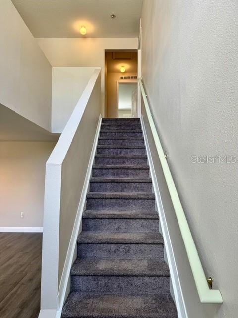 staircase featuring hardwood / wood-style flooring