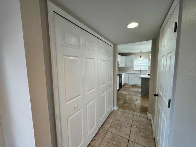 hallway featuring light tile patterned flooring