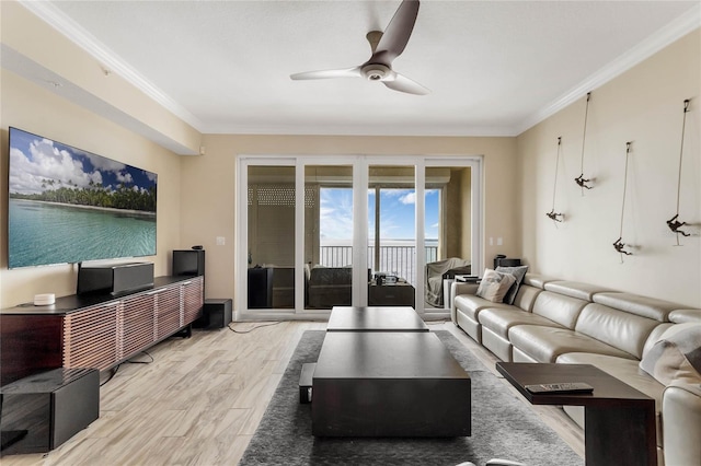 living room featuring ornamental molding, light wood-type flooring, and ceiling fan