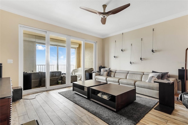 living room with crown molding, ceiling fan, and light hardwood / wood-style floors