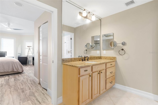 bathroom with tile patterned floors, ceiling fan, and vanity