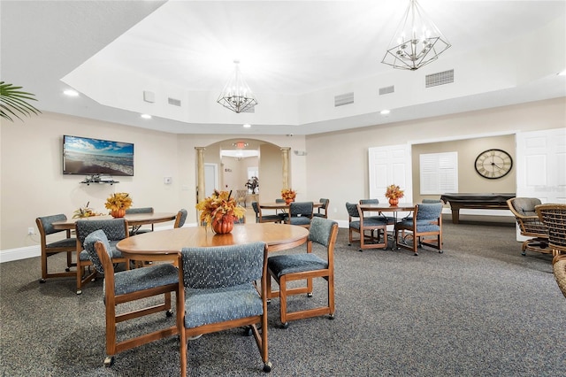 dining room with pool table, a chandelier, and a tray ceiling