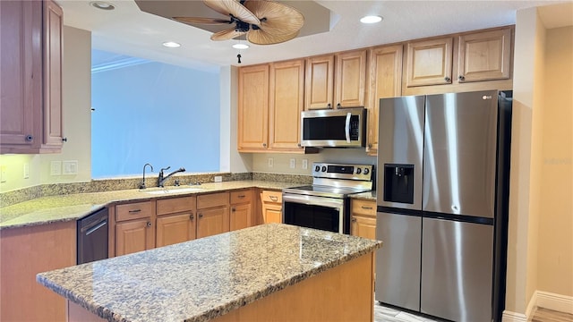93 Delannoy Ave Unit 904, Cocoa, FL 32922 - kitchen with stainless steel appliances, a sink, ceiling fan, light stone countertops, and light brown cabinetry