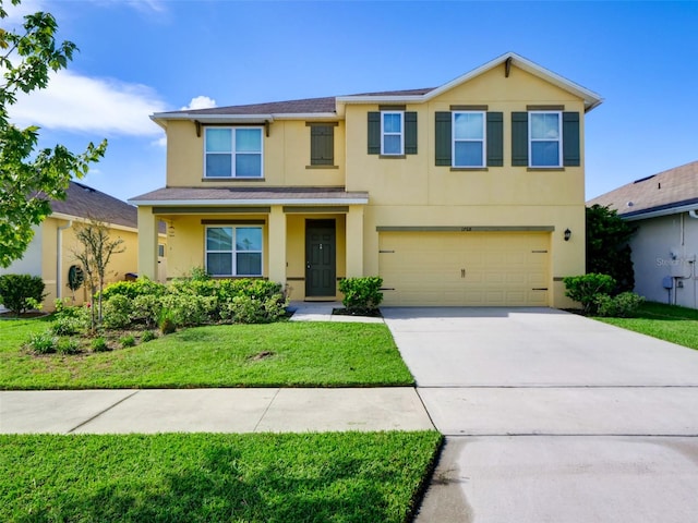 view of front of property with a garage and a front lawn