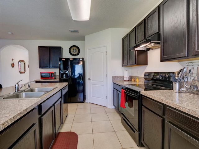 kitchen with black appliances, sink, light tile patterned floors, and dark brown cabinetry