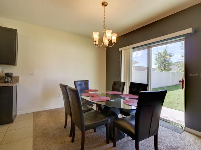 dining space with a chandelier and light tile patterned flooring