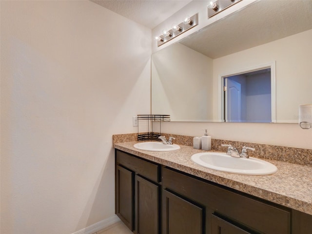 bathroom featuring a textured ceiling and vanity