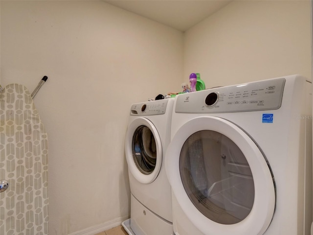 clothes washing area with separate washer and dryer