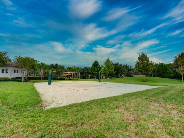 view of property's community with a yard and volleyball court