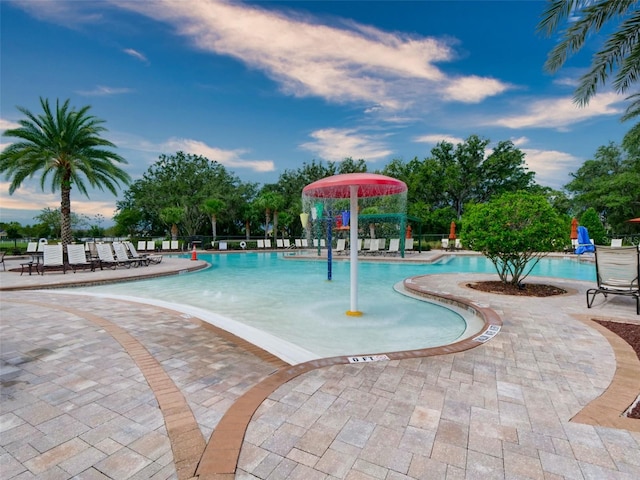 view of swimming pool with a patio and pool water feature