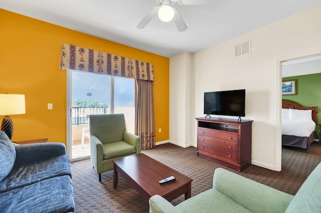 carpeted living room with ceiling fan