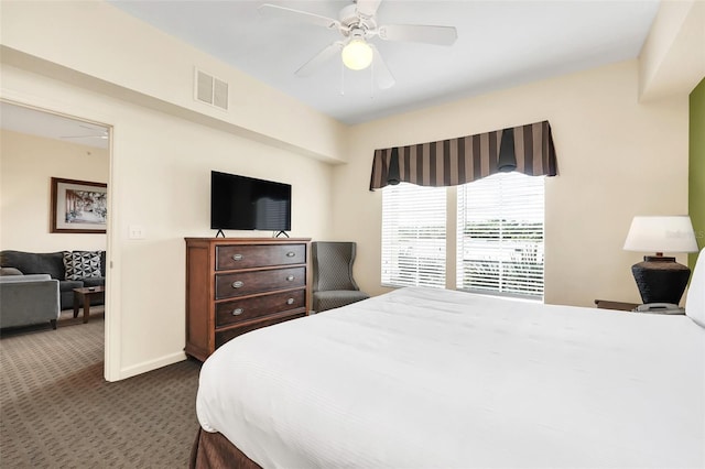 bedroom featuring a ceiling fan, baseboards, visible vents, and dark colored carpet