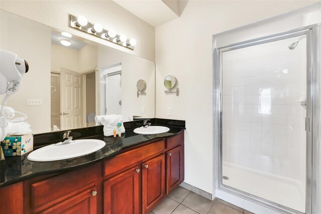 bathroom with vanity, tile patterned floors, and an enclosed shower