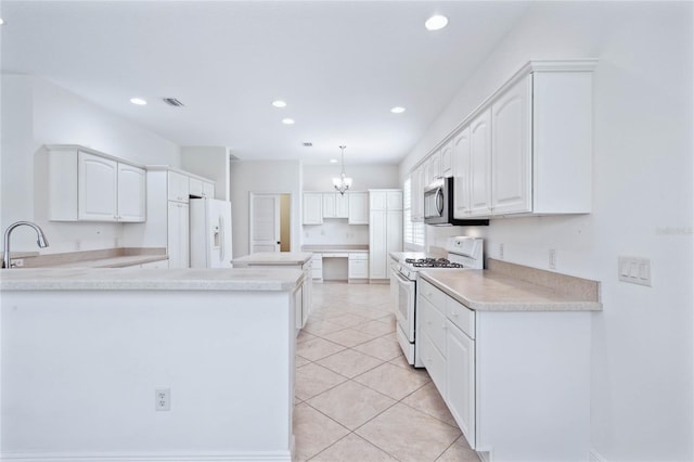 kitchen featuring hanging light fixtures, light tile patterned floors, an inviting chandelier, white appliances, and white cabinetry