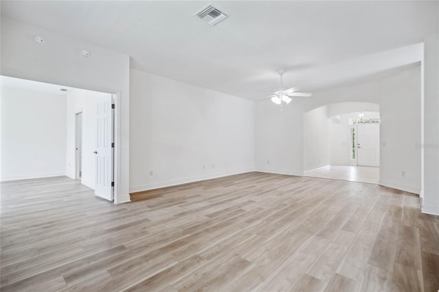 empty room with light hardwood / wood-style flooring and ceiling fan