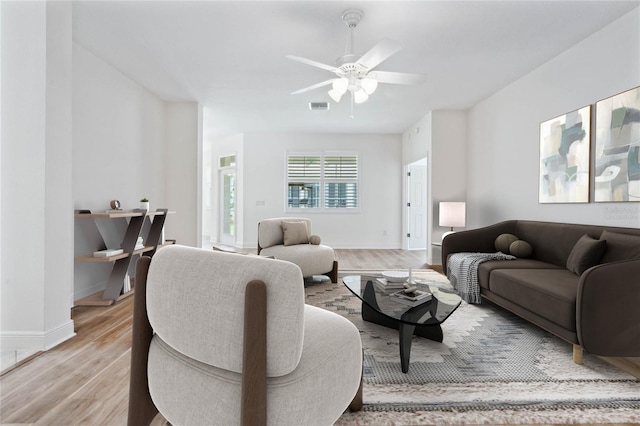 living room featuring ceiling fan and light hardwood / wood-style floors