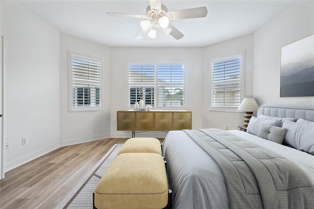 bedroom with ceiling fan and light wood-type flooring