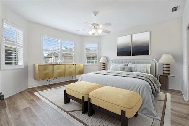 bedroom with ceiling fan and light hardwood / wood-style floors