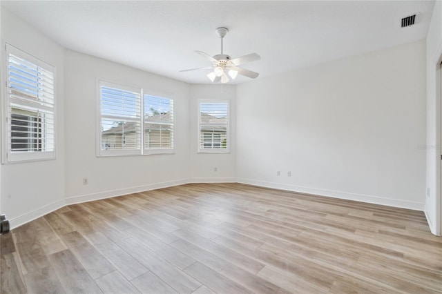 spare room with ceiling fan and light wood-type flooring