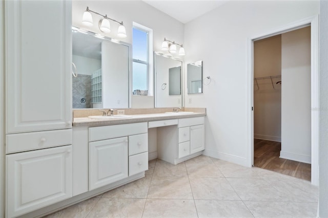 bathroom featuring vanity, a shower, and tile patterned flooring