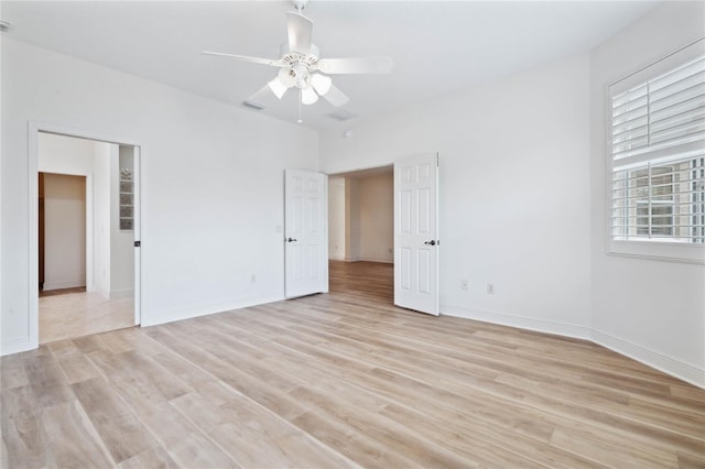 empty room featuring light hardwood / wood-style flooring and ceiling fan