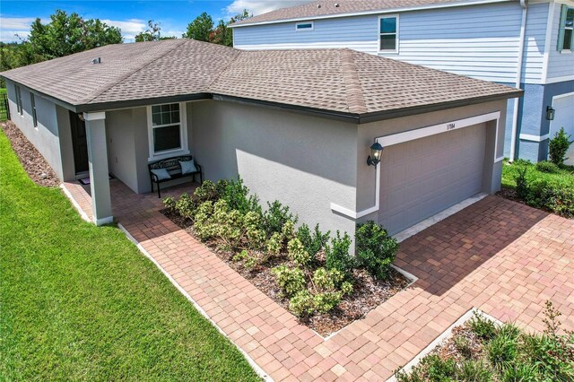 view of front of property with a front lawn and a garage