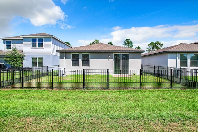 view of front of property with a front lawn, fence, and stucco siding