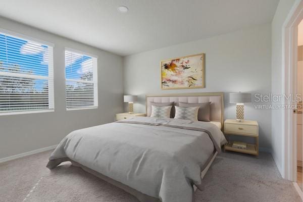 carpeted bedroom with baseboards