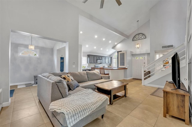 tiled living room with high vaulted ceiling and ceiling fan