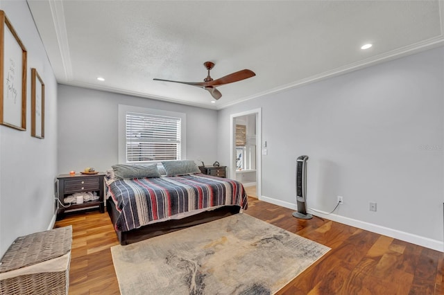 bedroom with ceiling fan, hardwood / wood-style flooring, a textured ceiling, and ornamental molding