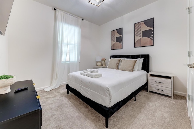 bedroom featuring light carpet