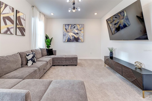 carpeted living room featuring a notable chandelier