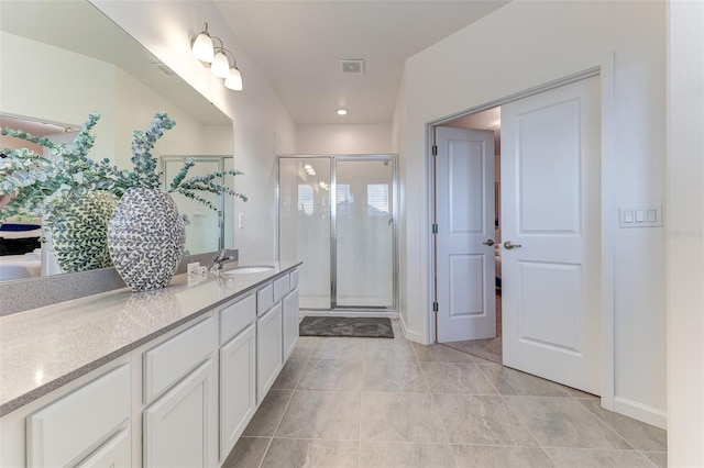 bathroom with tile patterned floors, an enclosed shower, and vanity