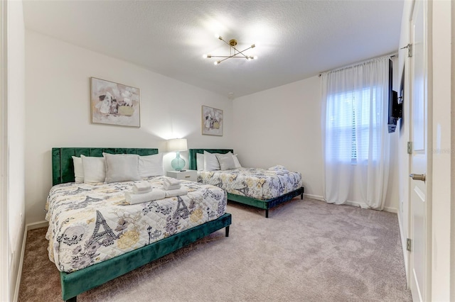 bedroom featuring a textured ceiling and carpet flooring